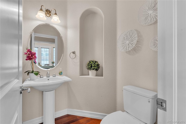 8053 E Maple Ave, Denver, CO 80230 - half bath with toilet, baseboards, and wood finished floors