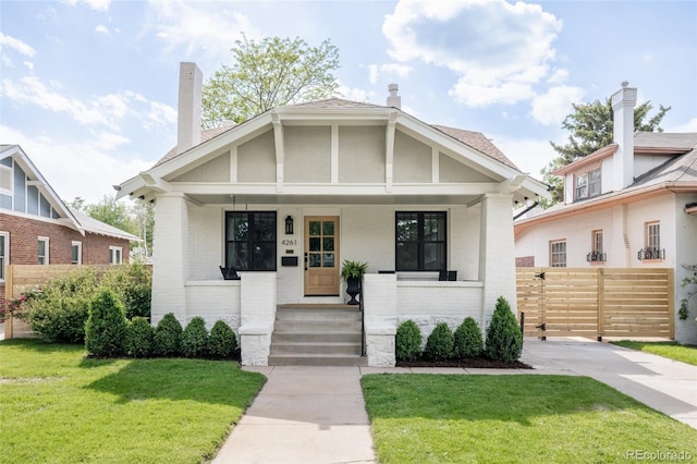 4261 Julian St, Denver, CO 80211 - view of front of home featuring a porch, brick siding, and a chimney