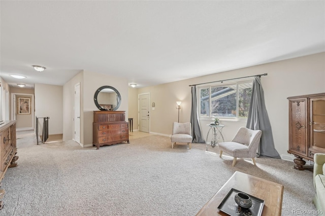 interior space with baseboards and light carpet