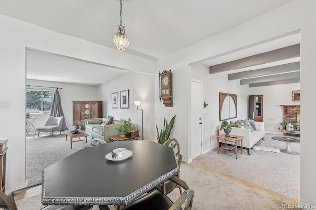 dining space with light colored carpet, baseboards, and beam ceiling