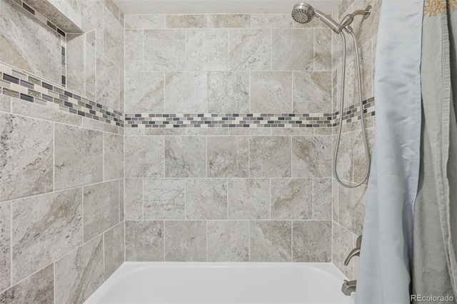 bathroom with shower / bath combination with curtain