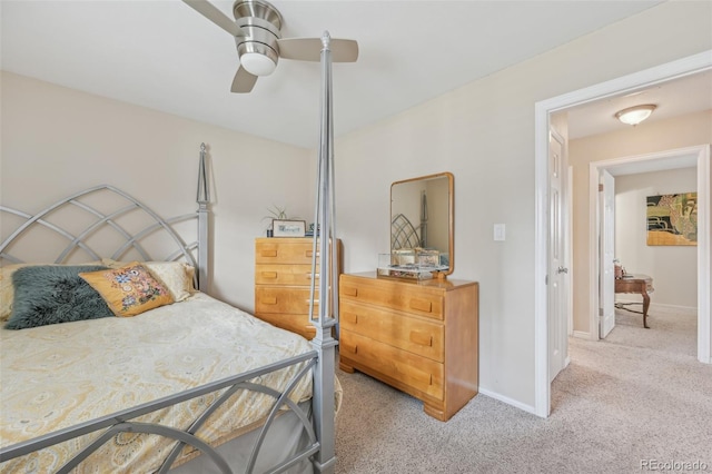 carpeted bedroom featuring baseboards and a ceiling fan
