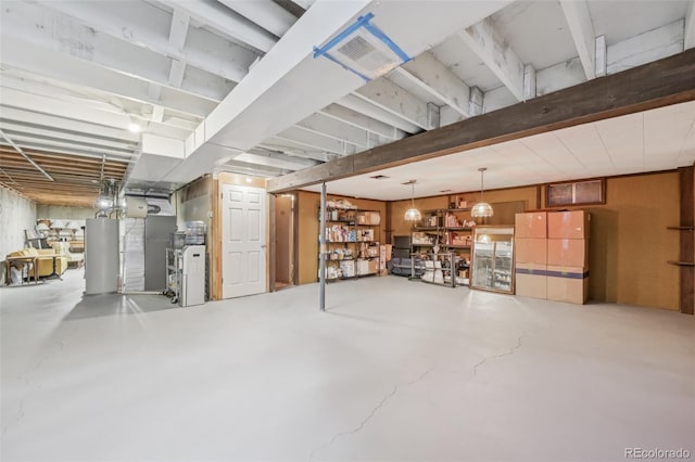 basement with gas water heater and visible vents
