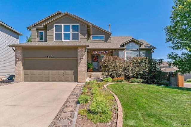 6590 S Tabor St, Littleton, CO 80127 - view of front facade featuring a garage and a front lawn