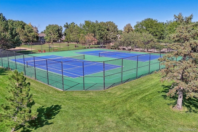 view of tennis court with a lawn