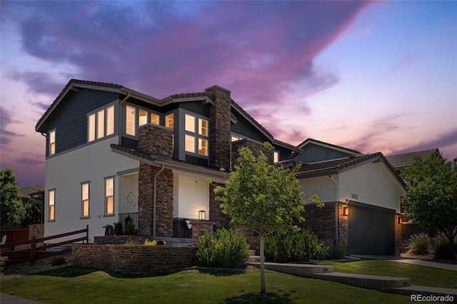 14110 Pastel Ln, Parker, CO 80134 - view of front of house featuring stone siding, a front yard, and an attached garage