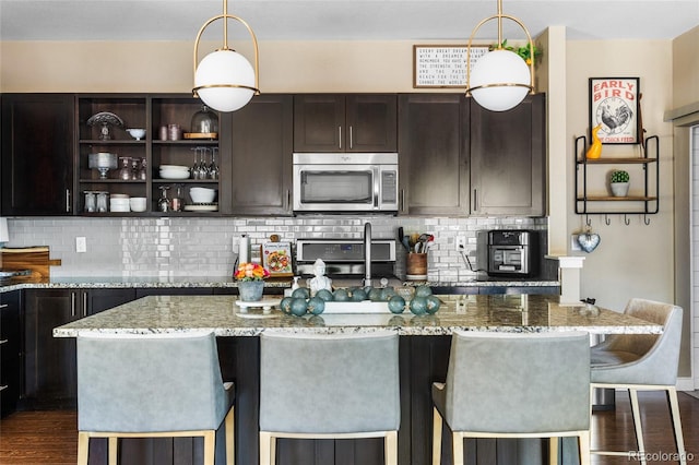 14110 Pastel Ln, Parker, CO 80134 - kitchen with stainless steel microwave, range, light stone countertops, and decorative backsplash