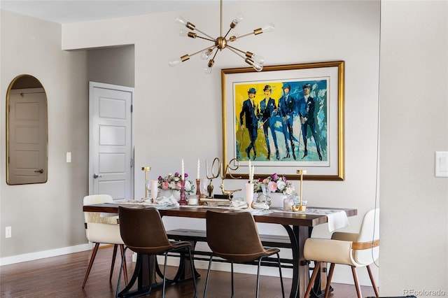 14110 Pastel Ln, Parker, CO 80134 - dining room featuring wood finished floors, a chandelier, and arched walkways
