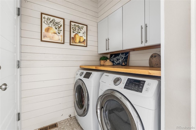 14110 Pastel Ln, Parker, CO 80134 - laundry area with washing machine and dryer, cabinet space, and wooden walls