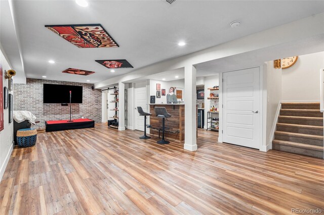 14110 Pastel Ln, Parker, CO 80134 - living area featuring a bar, stairway, brick wall, light wood-style flooring, and recessed lighting