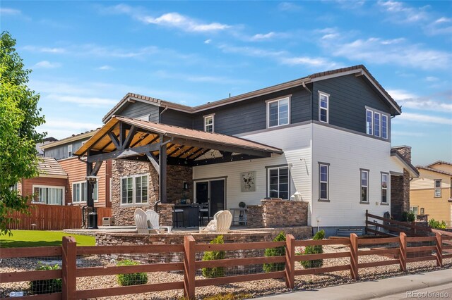 14110 Pastel Ln, Parker, CO 80134 - view of front of house featuring a fenced front yard, stone siding, and a patio area