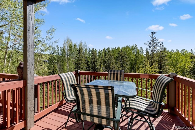 1508 Berino Ct Unit C, Frisco, CO 80443 - wooden terrace featuring outdoor dining area and a wooded view