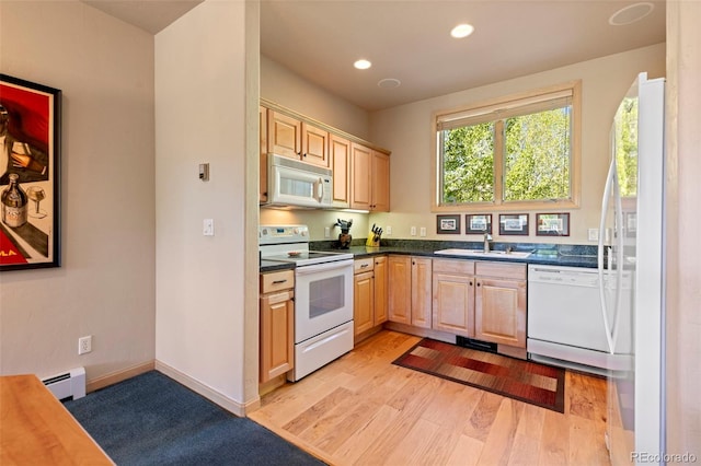 1508 Berino Ct Unit C, Frisco, CO 80443 - kitchen with white appliances, a baseboard radiator, light brown cabinetry, dark countertops, and light wood finished floors