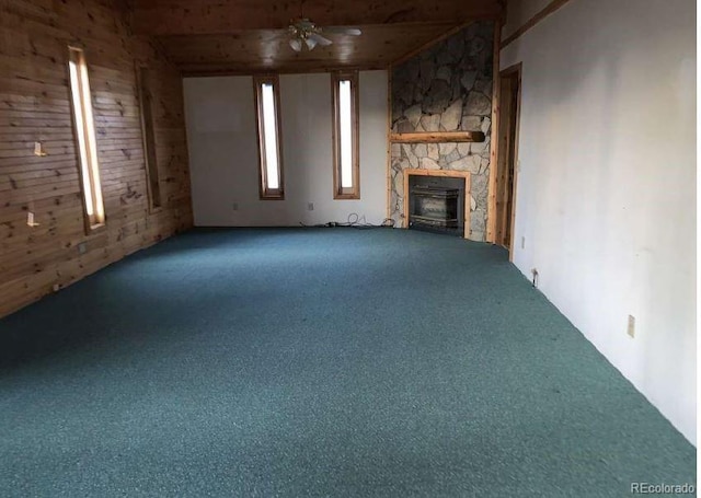 unfurnished living room with carpet flooring, a fireplace, and ceiling fan