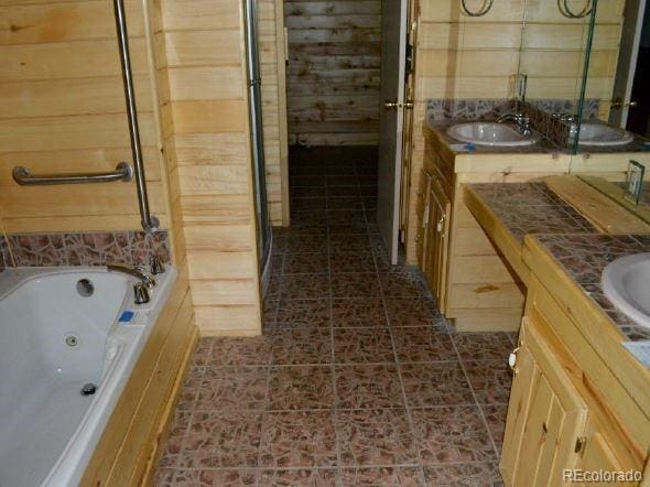 bathroom with vanity and a tub to relax in