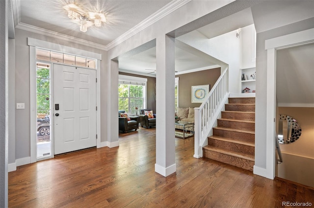 2746 Geneva St, Denver, CO 80238 - foyer entrance with stairway, wood finished floors, ornamental molding, and a chandelier