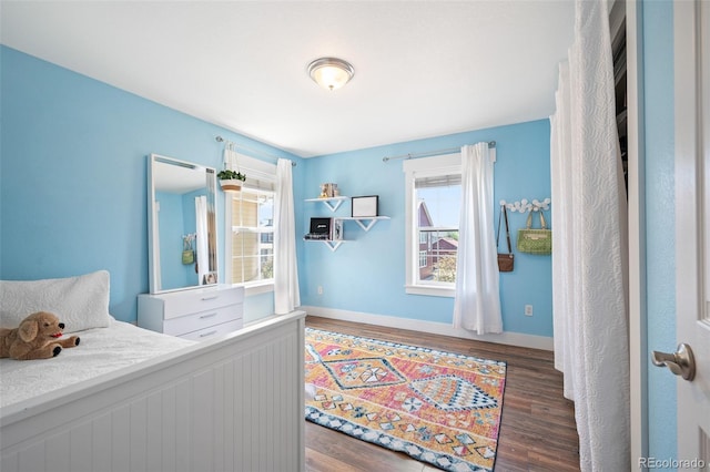 2746 Geneva St, Denver, CO 80238 - bedroom featuring multiple windows and wood finished floors