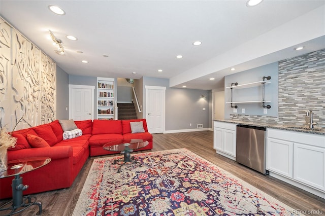 2746 Geneva St, Denver, CO 80238 - living room featuring bar with sink, light wood-type flooring, recessed lighting, and stairway