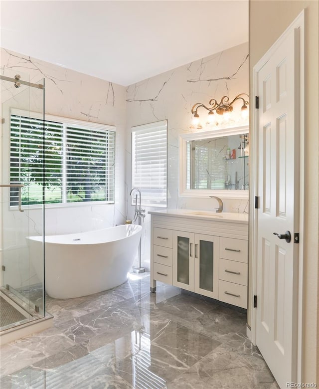 19249 E Progress Ave, Centennial, CO 80015 - bathroom with marble tiled floors, vanity, a freestanding tub, a stall shower, and stone wall