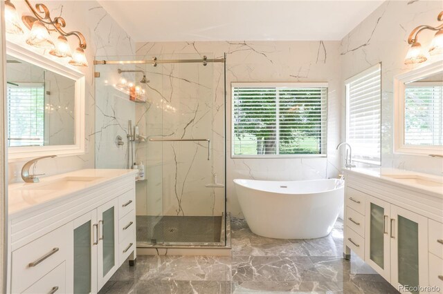 19249 E Progress Ave, Centennial, CO 80015 - bathroom featuring marble tiled floors, vanity, a marble finish shower, and a soaking tub