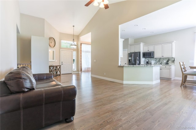 19249 E Progress Ave, Centennial, CO 80015 - living room featuring high vaulted ceiling, light wood finished floors, and ceiling fan