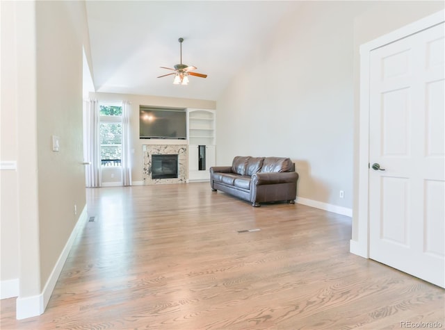 19249 E Progress Ave, Centennial, CO 80015 - living area featuring ceiling fan, light wood finished floors, a glass covered fireplace, lofted ceiling, and built in features