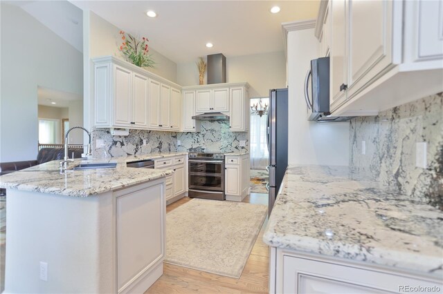 19249 E Progress Ave, Centennial, CO 80015 - kitchen with appliances with stainless steel finishes, a peninsula, decorative backsplash, recessed lighting, and light wood-style flooring