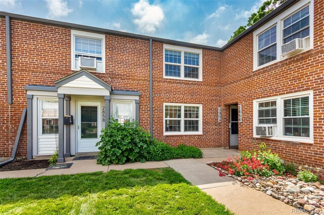 2856 Jasmine St, Denver, CO 80207 - multi unit property featuring brick siding and a front lawn