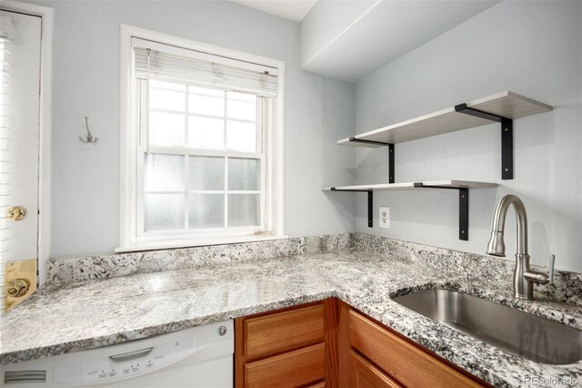 2856 Jasmine St, Denver, CO 80207 - kitchen featuring a sink, white dishwasher, open shelves, brown cabinetry, and light stone countertops