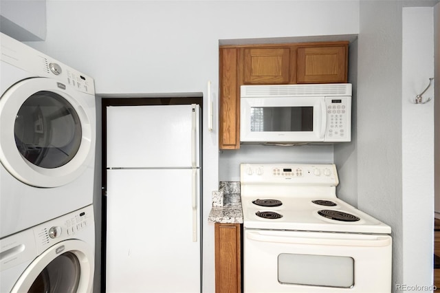 2856 Jasmine St, Denver, CO 80207 - kitchen with white appliances, estacked washer and dryer, brown cabinets, and light countertops