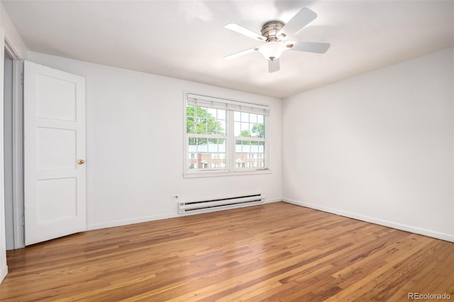 2856 Jasmine St, Denver, CO 80207 - unfurnished room with a baseboard heating unit, light wood finished floors, and baseboards