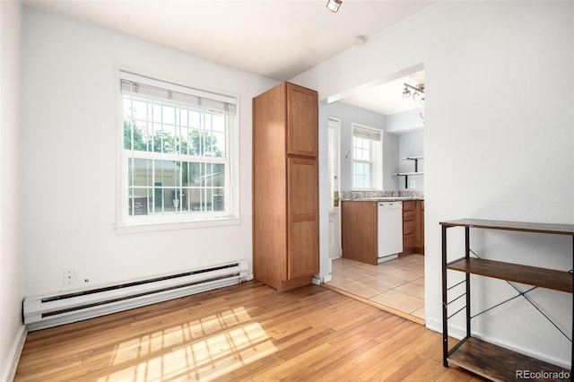 2856 Jasmine St, Denver, CO 80207 - unfurnished room with a baseboard heating unit and light wood-style flooring