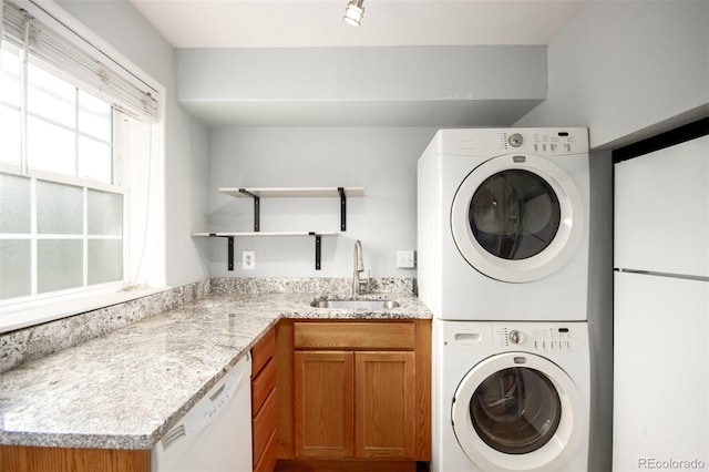2856 Jasmine St, Denver, CO 80207 - laundry room featuring stacked washer and clothes dryer and a sink