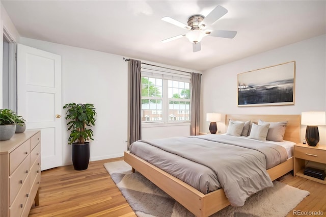 2856 Jasmine St, Denver, CO 80207 - bedroom with light wood-type flooring, ceiling fan, and baseboards