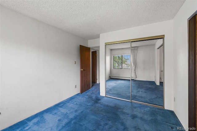 13890 E Marina Dr Unit 304, Aurora, CO 80014 - unfurnished bedroom featuring carpet, a closet, a textured ceiling, and baseboard heating