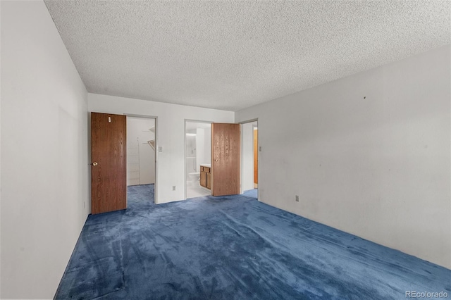 13890 E Marina Dr Unit 304, Aurora, CO 80014 - unfurnished bedroom with carpet, a textured ceiling, and connected bathroom