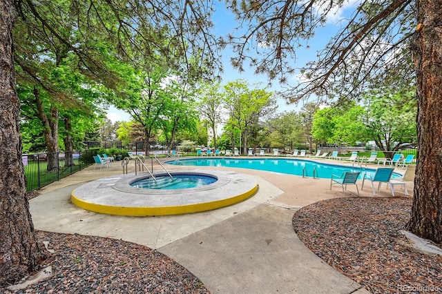 13890 E Marina Dr Unit 304, Aurora, CO 80014 - community pool featuring a hot tub, a patio area, and view of wooded area