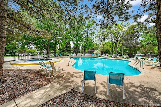 13890 E Marina Dr Unit 304, Aurora, CO 80014 - community pool featuring a patio, view of scattered trees, and a hot tub
