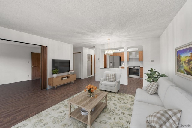 13890 E Marina Dr Unit 304, Aurora, CO 80014 - living area featuring wood finished floors, a chandelier, and a textured ceiling