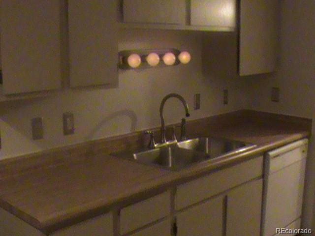 kitchen featuring white cabinetry and sink