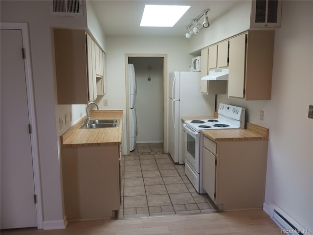 1845 N Kendall St Unit 316D, Lakewood, CO 80214 - kitchen featuring white appliances, a sink, a baseboard heating unit, under cabinet range hood, and a skylight