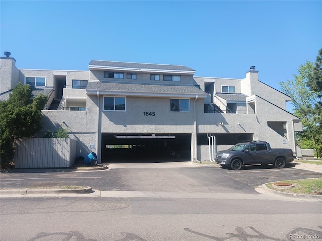 1845 N Kendall St Unit 316D, Lakewood, CO 80214 - view of property with a garage and asphalt driveway