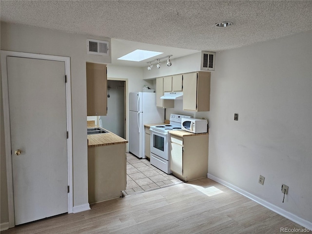 1845 N Kendall St Unit 316D, Lakewood, CO 80214 - kitchen featuring white appliances, a skylight, ventilation hood, light wood-type flooring, and a textured ceiling