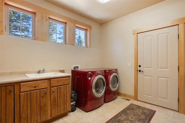 laundry room featuring light tile floors, cabinets, sink, hookup for a washing machine, and independent washer and dryer