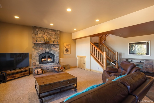 carpeted living room with a stone fireplace