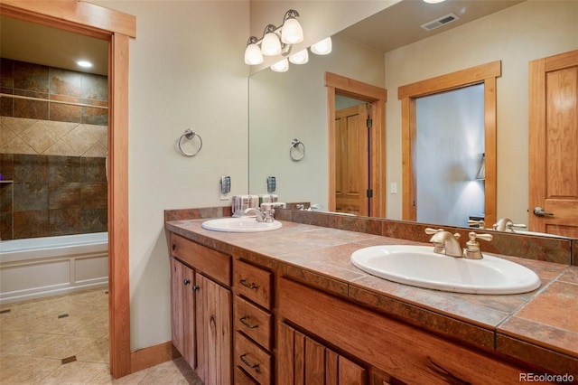 bathroom featuring tile floors, tiled shower / bath combo, double sink, and large vanity