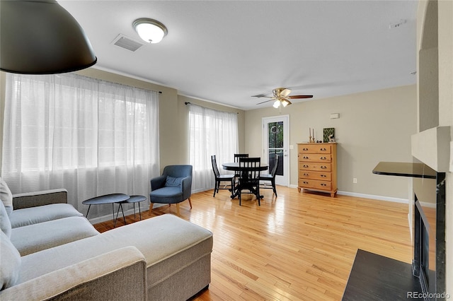 living room with hardwood / wood-style floors and ceiling fan