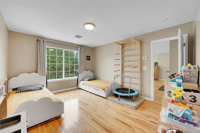 bedroom with hardwood / wood-style floors