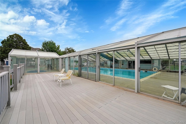 wooden terrace with a community pool