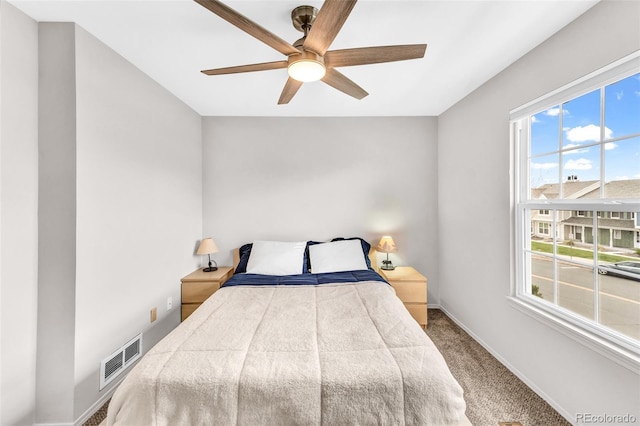 bedroom with baseboards, visible vents, multiple windows, and carpet